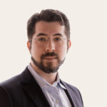 Headshot of Dr Ed Boyden, a white man with brown hair and beard, wearing glasses.