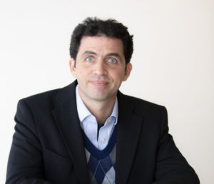 Headshot of Dr Manolis Kellis, a white man with black hair and blue eyes