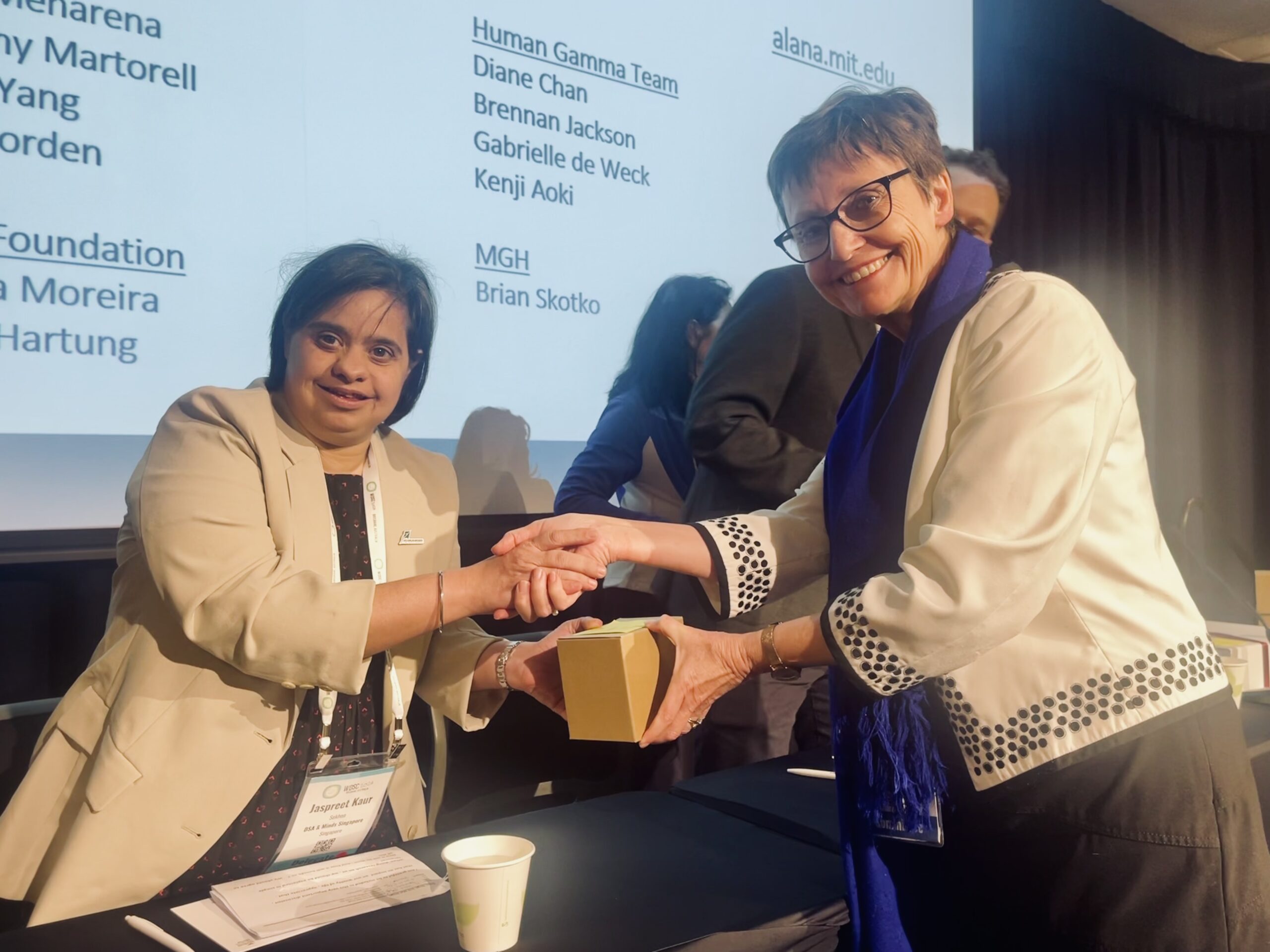 Panelist Jaspreet Kaur Sekhon shakes hands with the host, Professor Rhonda Faragher at the World Down Syndrome Congress.